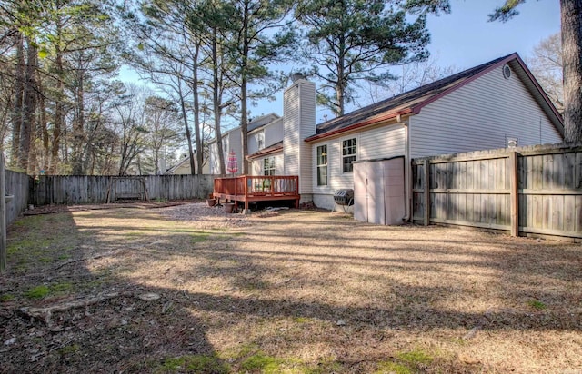 view of yard with a fenced backyard and a deck