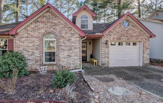 view of front facade featuring a shingled roof and an attached garage