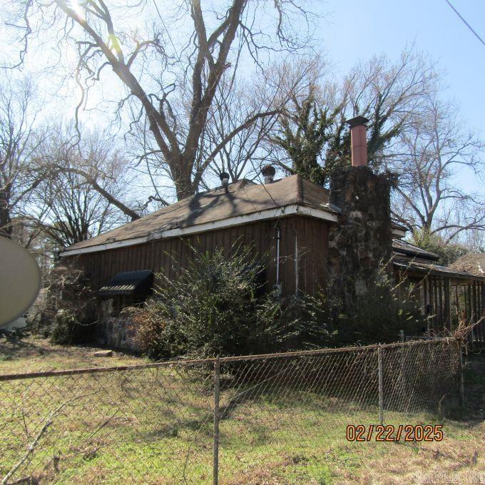 view of home's exterior with fence