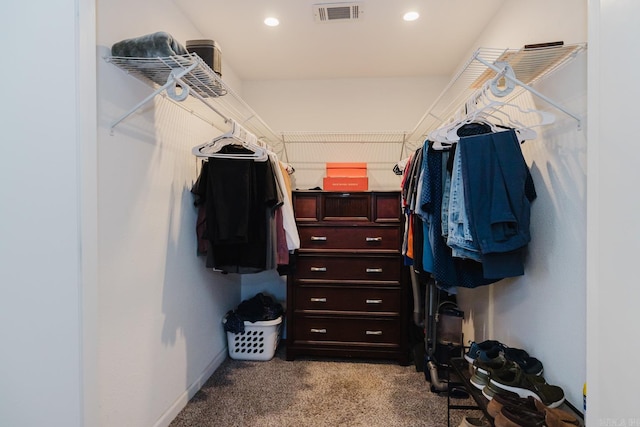 spacious closet with visible vents and light colored carpet