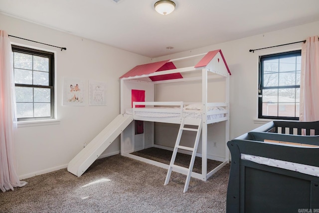 carpeted bedroom featuring baseboards