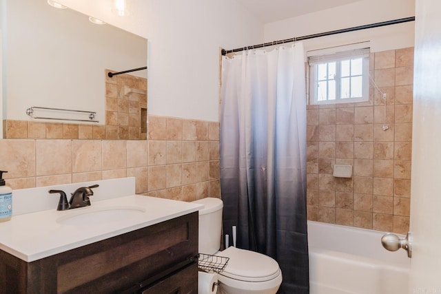 full bathroom featuring a wainscoted wall, tile walls, toilet, shower / tub combo, and vanity