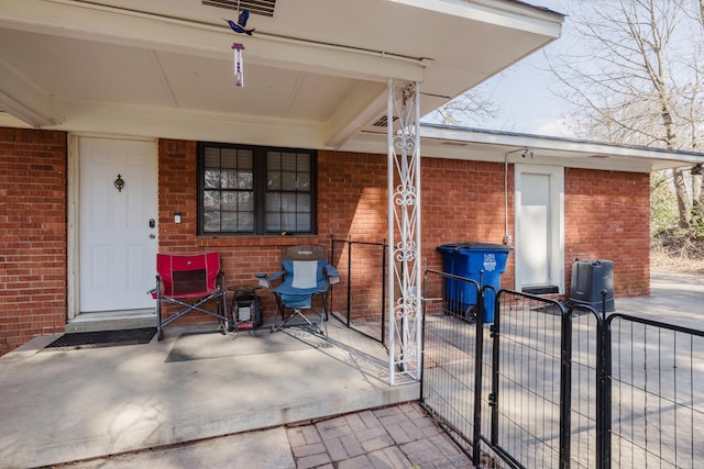 view of patio featuring a gate and fence