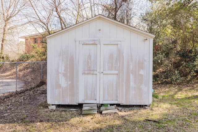 view of shed featuring fence