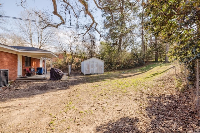 view of yard featuring cooling unit, an outdoor structure, and a storage shed