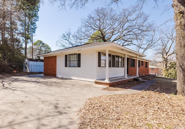 view of front of property featuring brick siding and driveway