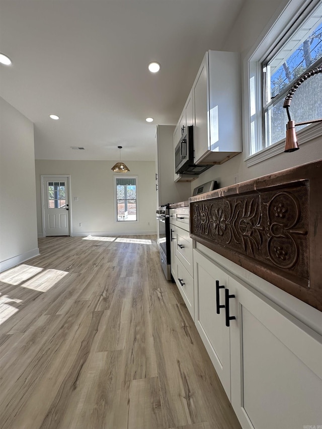 kitchen featuring stainless steel appliances, recessed lighting, white cabinetry, and light wood-style floors