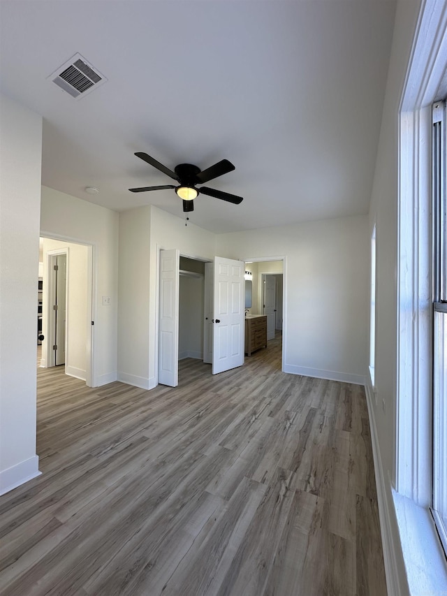 unfurnished bedroom with baseboards, visible vents, and light wood finished floors