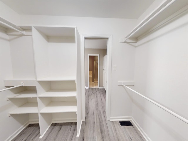 walk in closet featuring light wood finished floors and visible vents