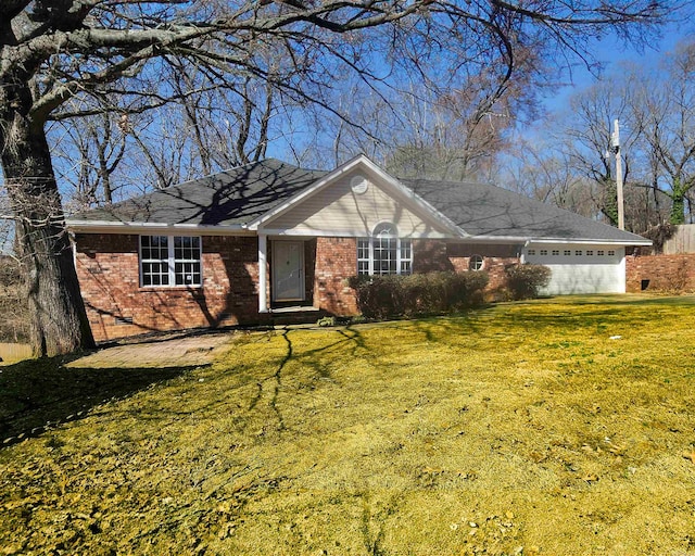 single story home with crawl space, brick siding, an attached garage, and a front lawn