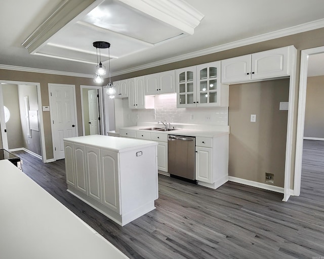 kitchen with white cabinets, light countertops, a center island, dishwasher, and glass insert cabinets