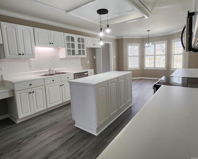 kitchen with pendant lighting, light countertops, glass insert cabinets, and white cabinetry