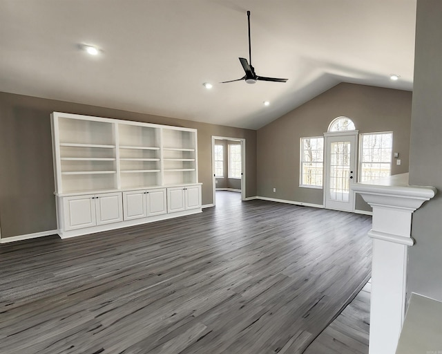 unfurnished living room with lofted ceiling, recessed lighting, ceiling fan, wood finished floors, and baseboards