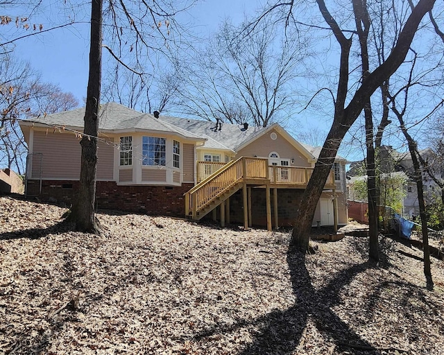 rear view of property with stairs, brick siding, crawl space, and a wooden deck