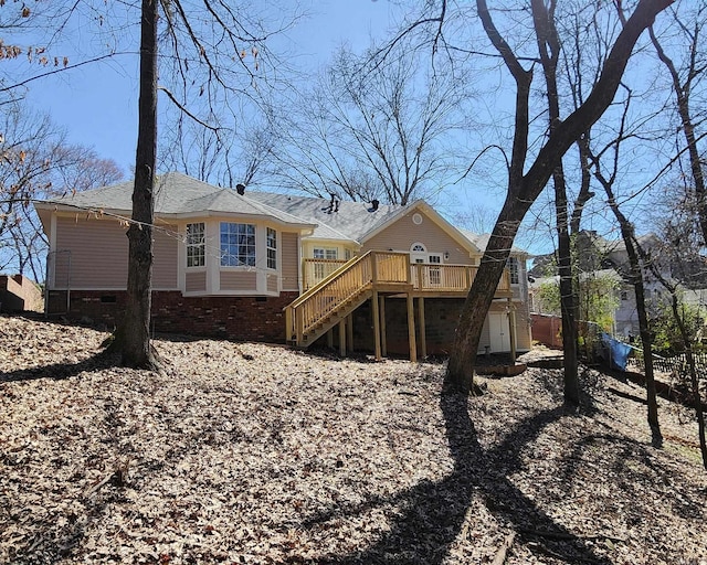 back of house with crawl space, stairway, and a wooden deck