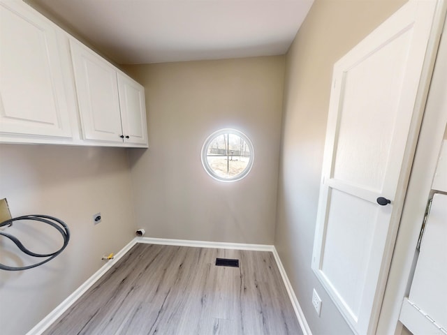 laundry room with cabinet space, baseboards, visible vents, hookup for a washing machine, and light wood-style floors