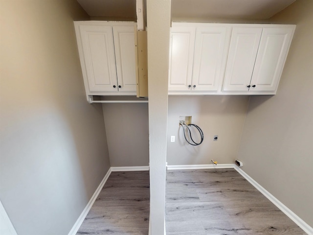 clothes washing area with light wood finished floors, baseboards, hookup for a gas dryer, hookup for a washing machine, and electric dryer hookup