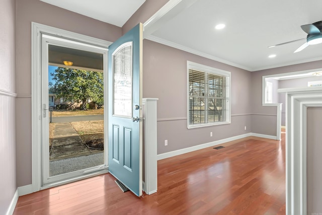 entrance foyer with a healthy amount of sunlight, visible vents, baseboards, and wood finished floors