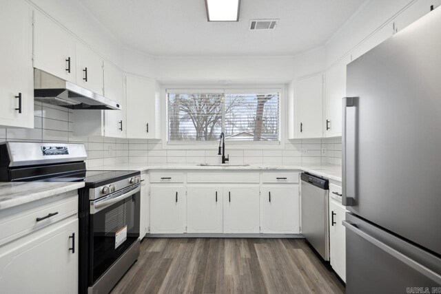 kitchen featuring stainless steel appliances, a sink, light countertops, and white cabinets