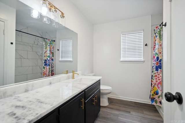 full bathroom with a shower with shower curtain, toilet, vanity, wood finished floors, and baseboards