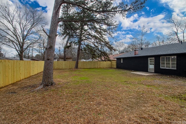 view of yard with a fenced backyard