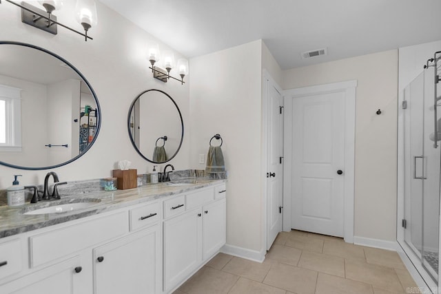 full bath with double vanity, visible vents, a sink, and tile patterned floors