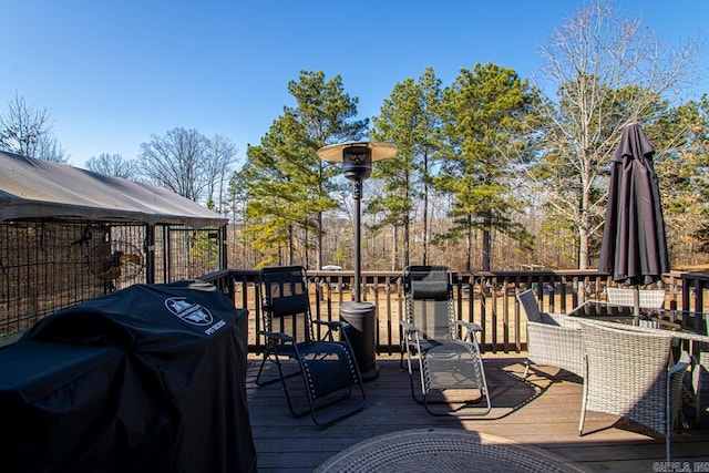 wooden terrace with a grill and a gazebo