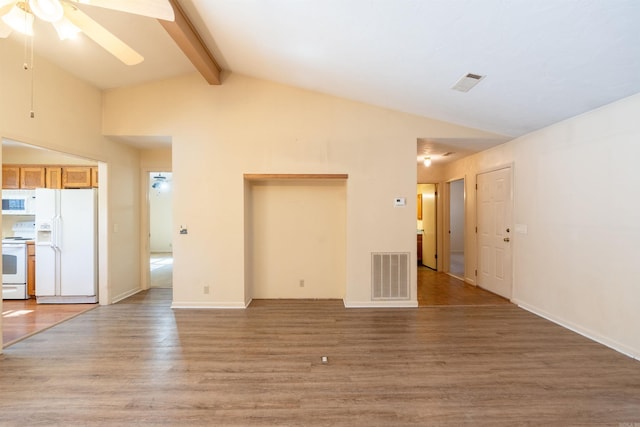 unfurnished living room featuring beamed ceiling, wood finished floors, visible vents, and a ceiling fan