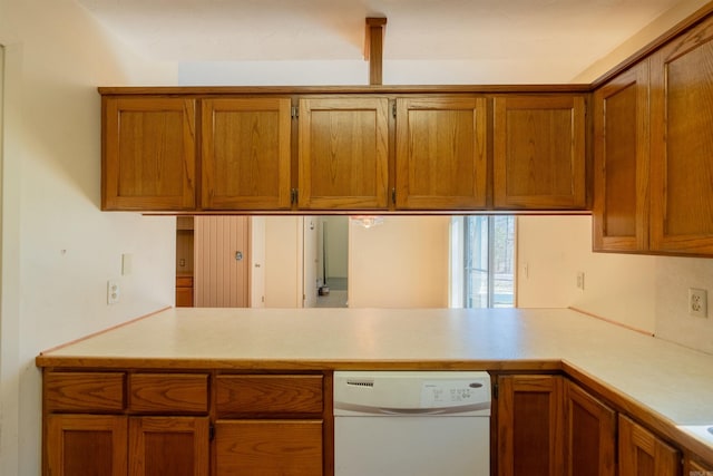 kitchen featuring dishwasher, light countertops, brown cabinetry, and a peninsula