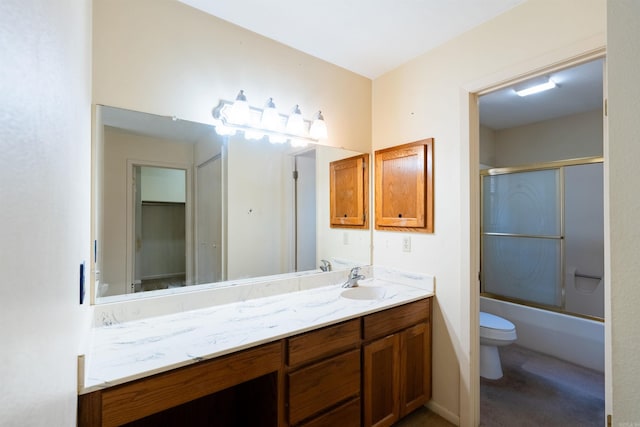 full bath with bath / shower combo with glass door, vanity, and toilet