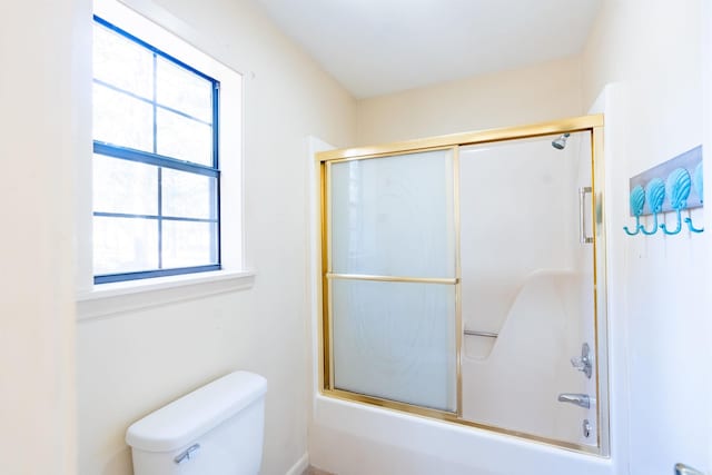 full bathroom with combined bath / shower with glass door and toilet