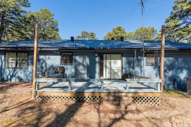 view of front of house featuring metal roof and a deck