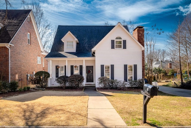 view of front of house with a porch and a front yard