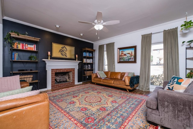 living room with ornamental molding, a fireplace, wood finished floors, and a ceiling fan