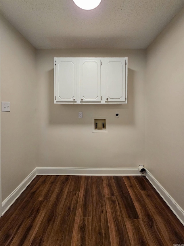 washroom with cabinet space, baseboards, and dark wood finished floors