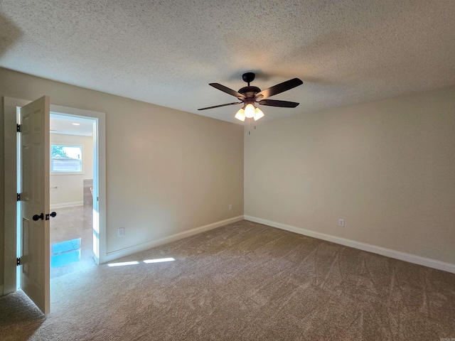 unfurnished room with a textured ceiling, carpet flooring, a ceiling fan, and baseboards