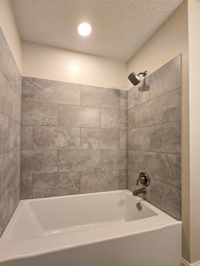 bathroom featuring recessed lighting, shower / bath combination, and a textured ceiling