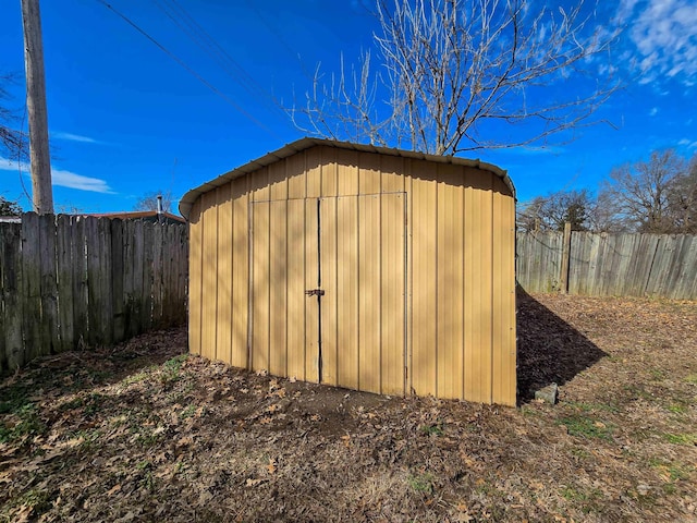 view of shed with a fenced backyard