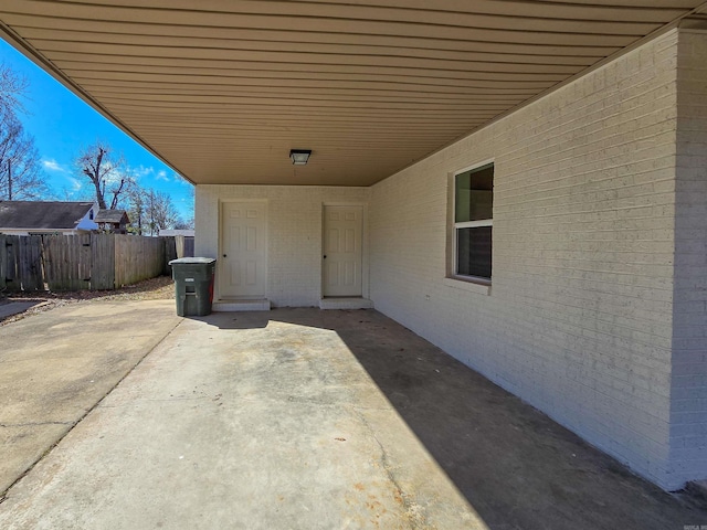 view of patio with a carport and fence