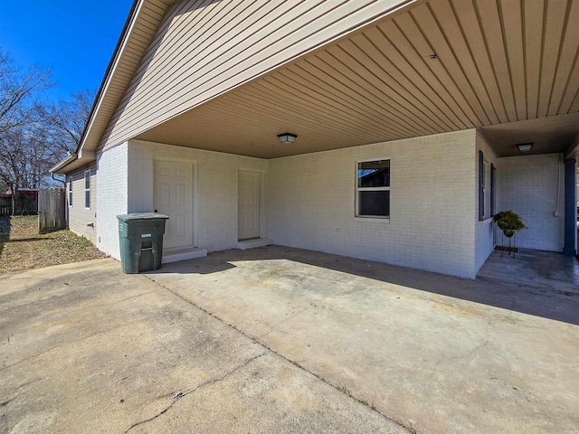 view of patio / terrace featuring an attached carport and concrete driveway