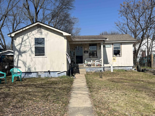 bungalow with covered porch, roof with shingles, and crawl space