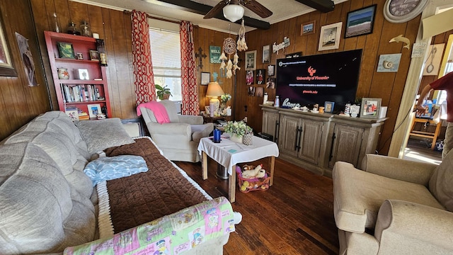 living room with dark wood-style floors, a ceiling fan, and wooden walls