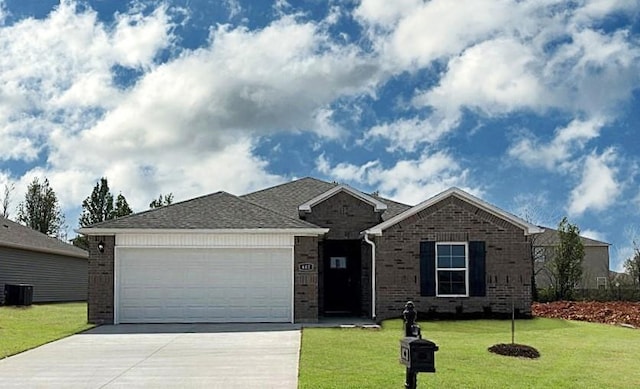 ranch-style house featuring brick siding, central air condition unit, concrete driveway, a front yard, and a garage