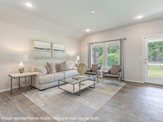 living room featuring lofted ceiling, baseboards, wood finished floors, and recessed lighting