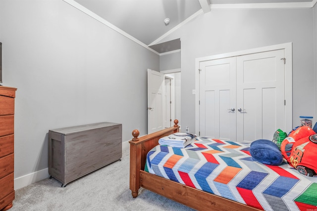 carpeted bedroom featuring baseboards, ornamental molding, vaulted ceiling, and a closet