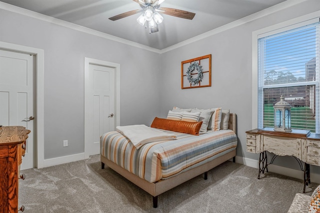 carpeted bedroom featuring crown molding, baseboards, and ceiling fan