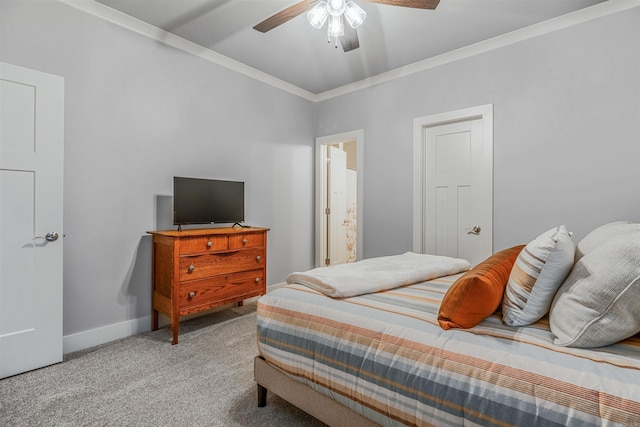 bedroom with carpet floors, ceiling fan, baseboards, and crown molding