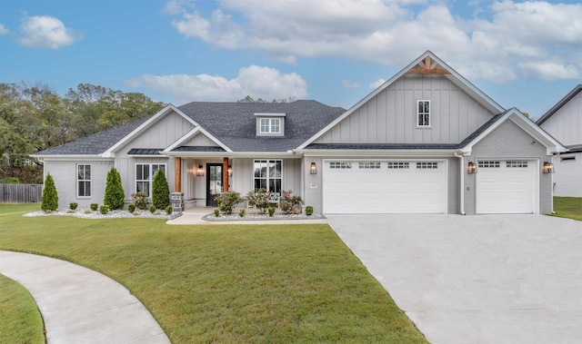 view of front of home featuring board and batten siding, a front yard, concrete driveway, and brick siding