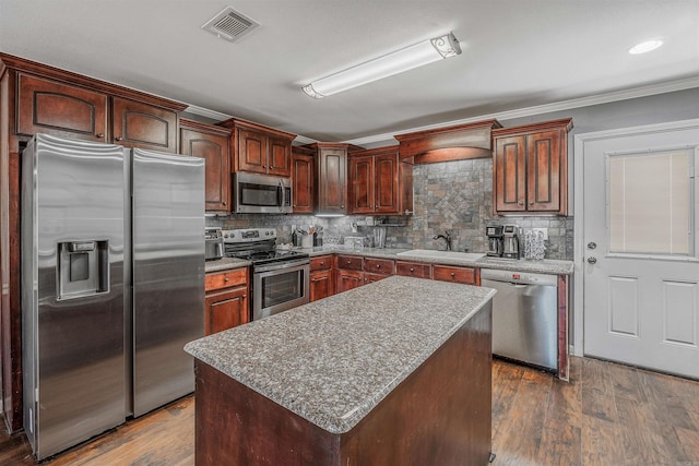 kitchen featuring dark wood-style floors, stainless steel appliances, visible vents, and crown molding