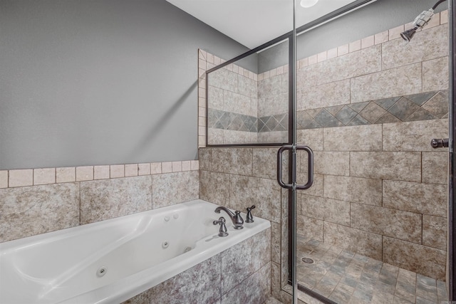 bathroom featuring a whirlpool tub and a shower stall